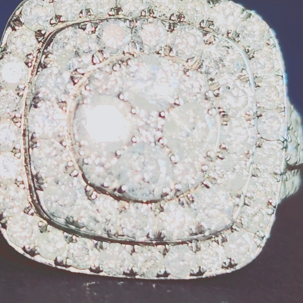 10k cruster center with a double halo diamond ring .